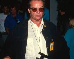 American actor Jack Nicholson, a pair of binoculars around his neck, attends a premiere of 'Batman' at the Mann Bruin Theater, Westwood, California, June 19, 1989. (Photo by Ron Galella, Ltd./Ron Galella Collection via Getty Images)