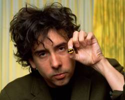 WEST HOLLYWOOD, CA - 1989:  Director of the first "Batman" movie and "Batman Returns," Tim Burton, proudly displays a Batman pin during a 1989 West Hollywood, California, photo portrait session. In addition to his "Batman" fame, Burton went on to direct such eclectic hits as "Ed Wood," "Beetle Juice," "Edward Scissorhands," and the "Corpse Bride".(Photo by George Rose/Getty Images)